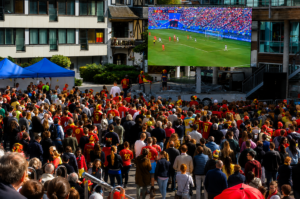 Mobile LED Jumbotron displaying a soccer match at a large outdoor watch party