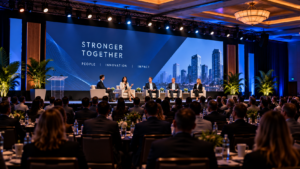 Corporate town hall panel discussion with LED video wall, stage lighting and professional AV production
